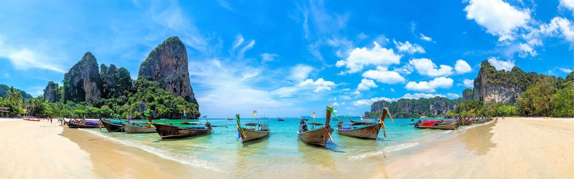 Longtailboote am weißen Sandstrand von Railay Beach, Thailand