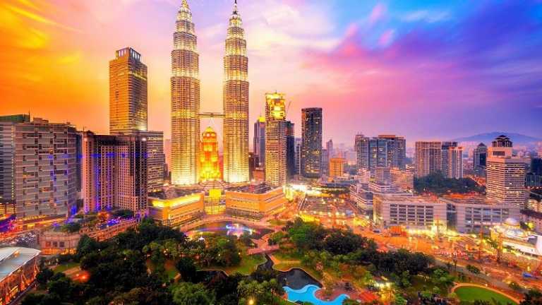 Skyline von Kuala Lumpur mit den Petronas Towers bei Sonnenuntergang