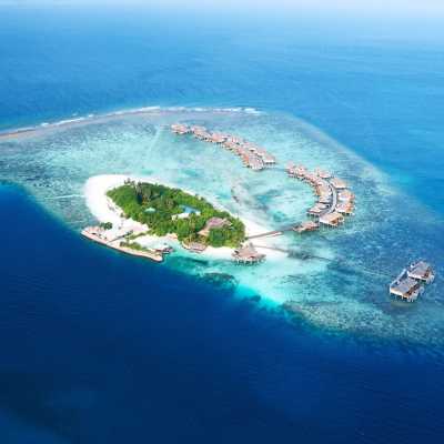 Tropische Luxusinsel mit Wasserbungalows im türkisblauen Ozean – Luftaufnahme eines Atolls