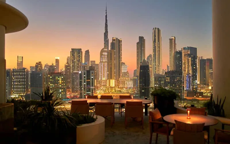 Luxus-Kombireise Dubai: Spektakulärer Blick von der Terrasse des Design-Hotels The Lana auf die abendliche Skyline mit dem Burj Khalifa – kuratierter Luxus von JUREBU.