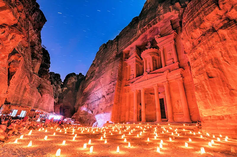 Jordanien Luxusreise Petra Schatzhaus bei Nacht beleuchtet mit hunderten Kerzen vor markanter Felskulisse